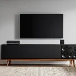 Home 20 홈시어터 예산별 추천 - **A contemporary and inviting living room transformed into a casual home cinema setting.** A large, ...